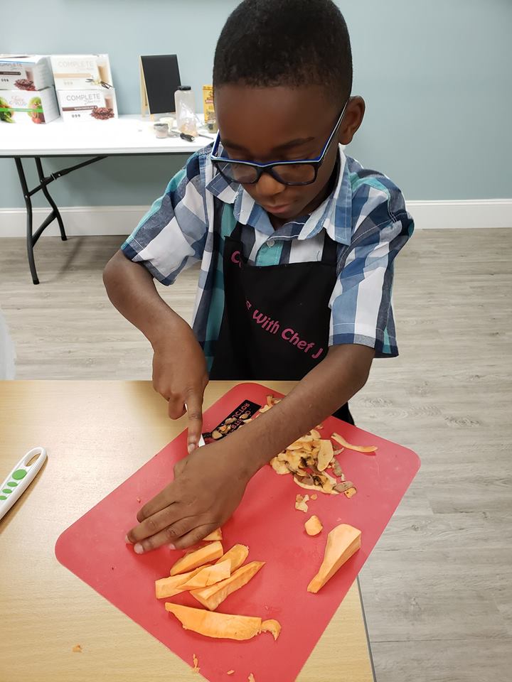 boy learning healthy cooking
